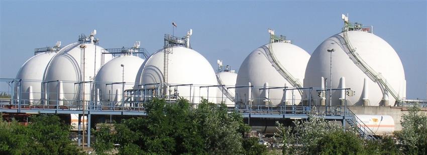 Multiple tanks forming a tank farm at an outdoor chemical plant